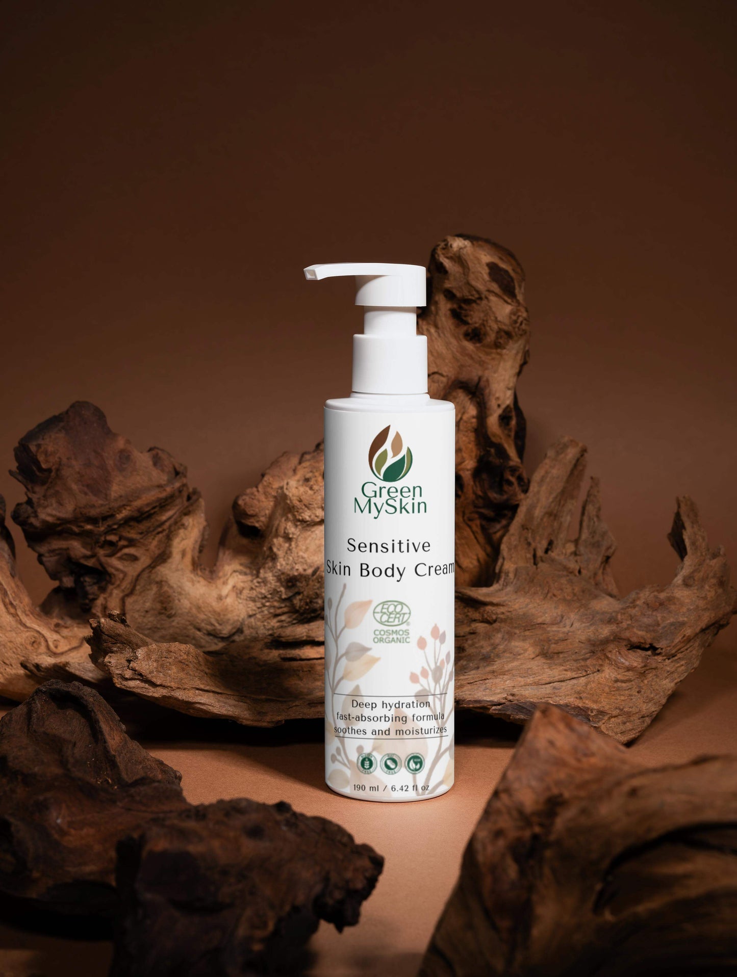 White bottle of Green My skin Sensitive Skin Body Cream on a brown background with natural elements.