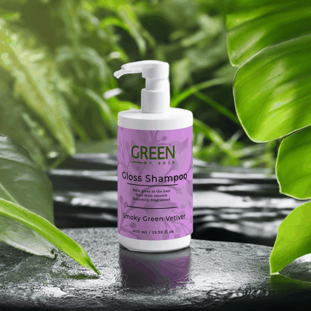 Gloss-shampoo with Smoky Green Vetiver, 400ml bottle on leafy background, for shiny, smooth, fragranced hair.