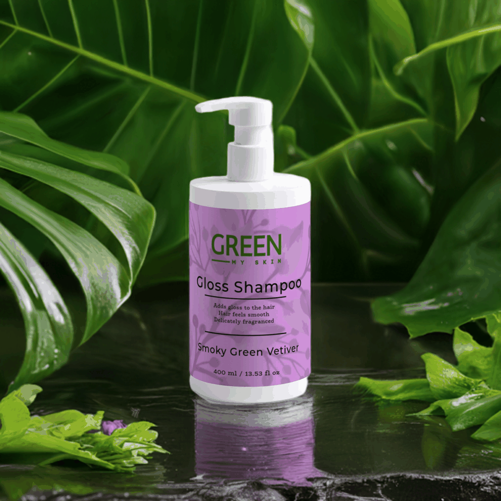 Gloss-shampoo bottle with Smoky Green Vetiver, surrounded by lush green leaves.