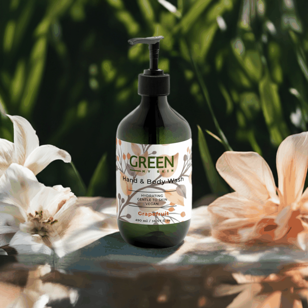 Hydrating vegan grapefruit hand and body wash bottle with floral backdrop.
