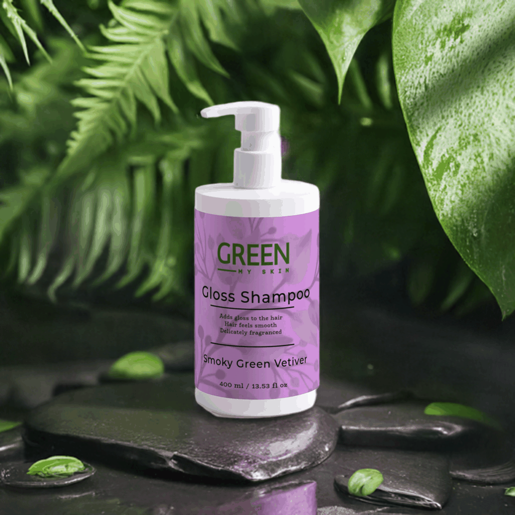 Gloss-shampoo bottle with Smoky Green Vetiver fragrance, surrounded by lush green leaves, adds gloss and a smooth feel.