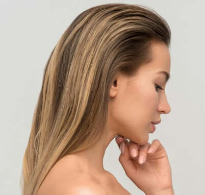 A side profile of a woman with long, flowing hair, indicating a link to hair care products.