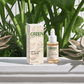 All-In-One Facial Oil with organic ingredients for hydration and glow, outdoors among lush green plants.