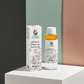 BiPhasic make-up remover bottle and box on a marble surface surrounded by green leaves.