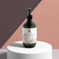 Hydrating vegan grapefruit hand and body wash bottle with floral backdrop.