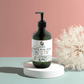 Ginger & Smoky Cardamom Hand-Body Wash, hydrating and vegan, in green pump bottle.