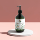 Hydrating hand and body wash with patchouli and amber vanilla scent in a pump bottle.