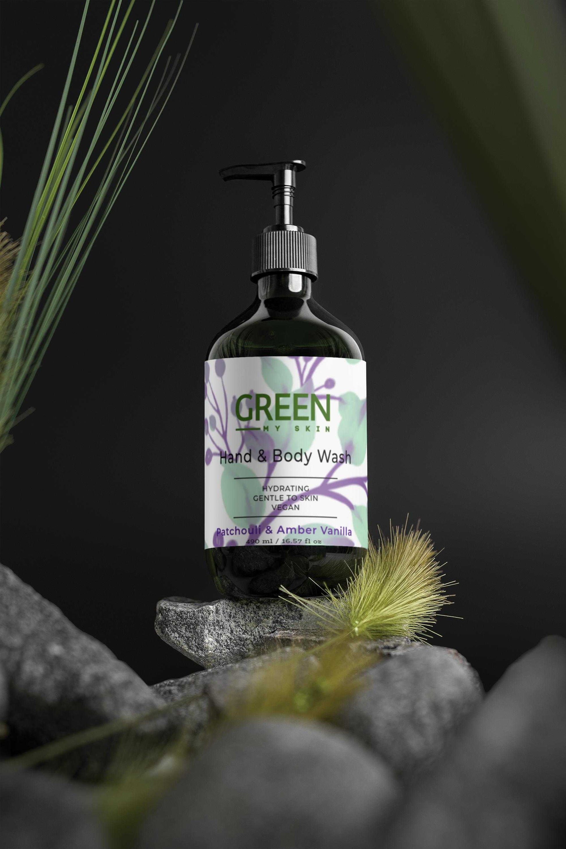 Hand and body wash bottle with Patchouli, Amber, and Vanilla scent on natural stone background.