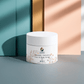 White jar of Icelandic Volcano Face & Body Scrub on a colorful background