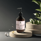 silk-skin-body-serum bottle with pump, offering deep hydration and woody amber & leather scent