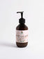 silk-skin-body-serum bottle with pump, offering deep hydration and woody amber & leather scent