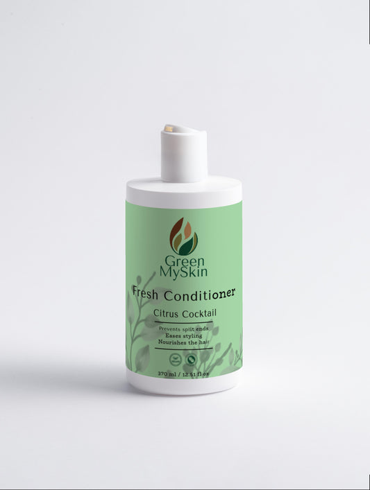 Citrus Cocktail Fresh-Conditioner bottle amidst lush greenery, ideal for preventing split ends and nourishing hair.