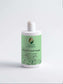 Citrus Cocktail Fresh-Conditioner bottle amidst lush greenery, ideal for preventing split ends and nourishing hair.