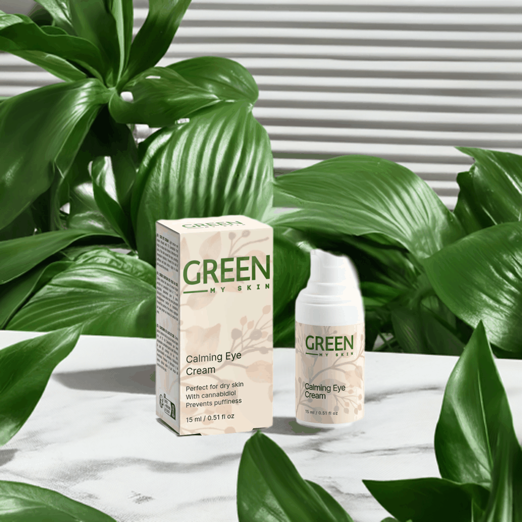 Calming eye cream bottle and box with cannabidiol for dry skin and puffiness prevention, surrounded by green leaves.