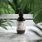 Silk Skin Body Serum bottle with greenery background, featuring deep hydration and natural ingredients.
