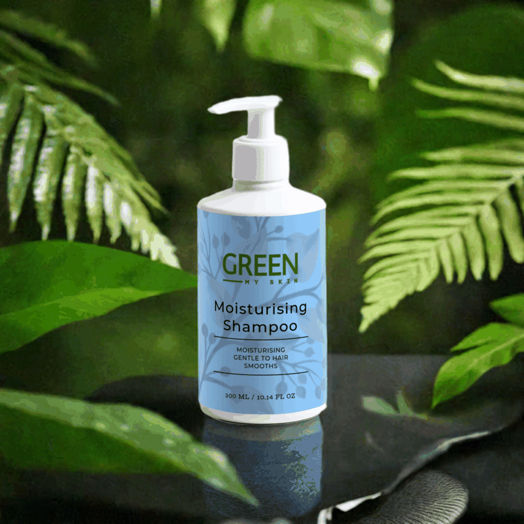 Moisturising shampoo bottle among green leaves for gentle daily hair care.