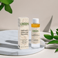 BiPhasic make-up remover bottle and box on a marble surface surrounded by green leaves.