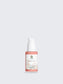 Skincare serum bottle with a white cap on a light gray background